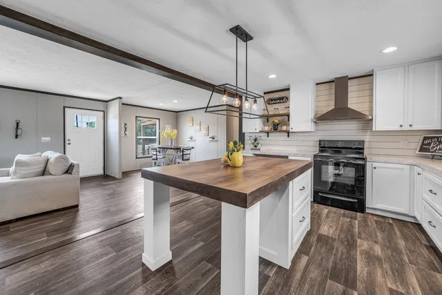 a view of a dining room with furniture wooden floor and a chandelier