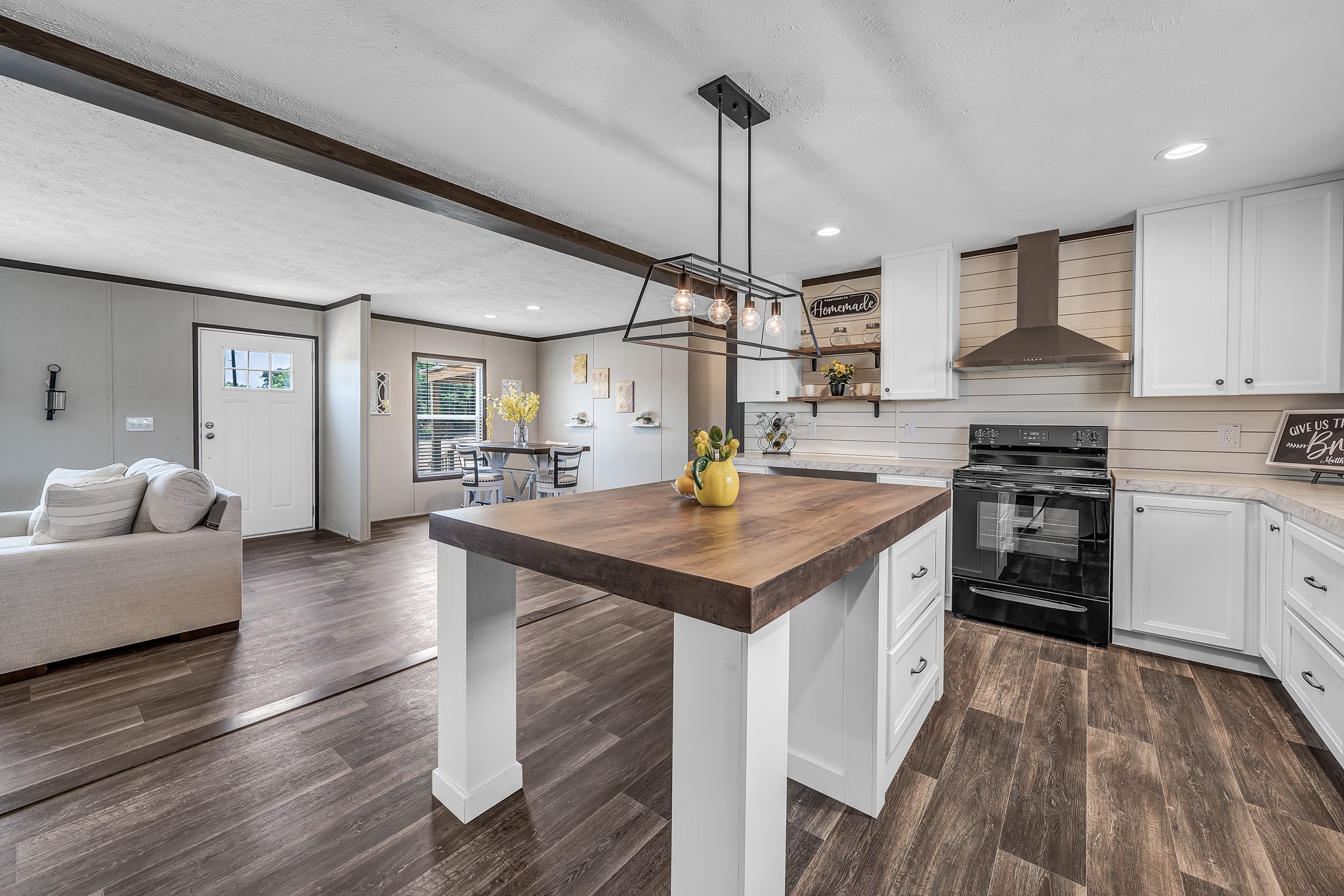 2747 Old Masonic Road Brenham, TX 77833 - Photo 13 of 28 a kitchen with stainless steel appliances granite countertop a stove refrigerator and wooden floor