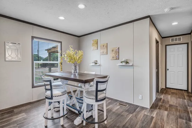 a view of an empty room with a window and a ceiling fan