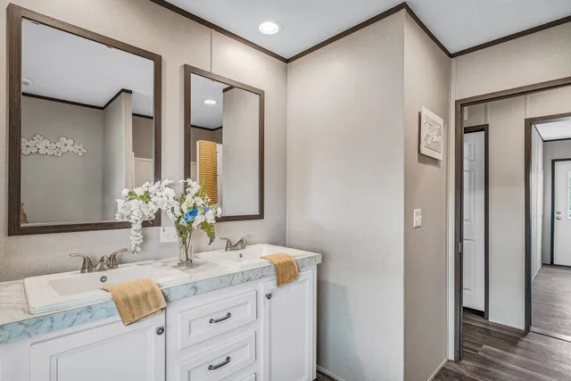 a view of an empty room with a window and hardwood floor
