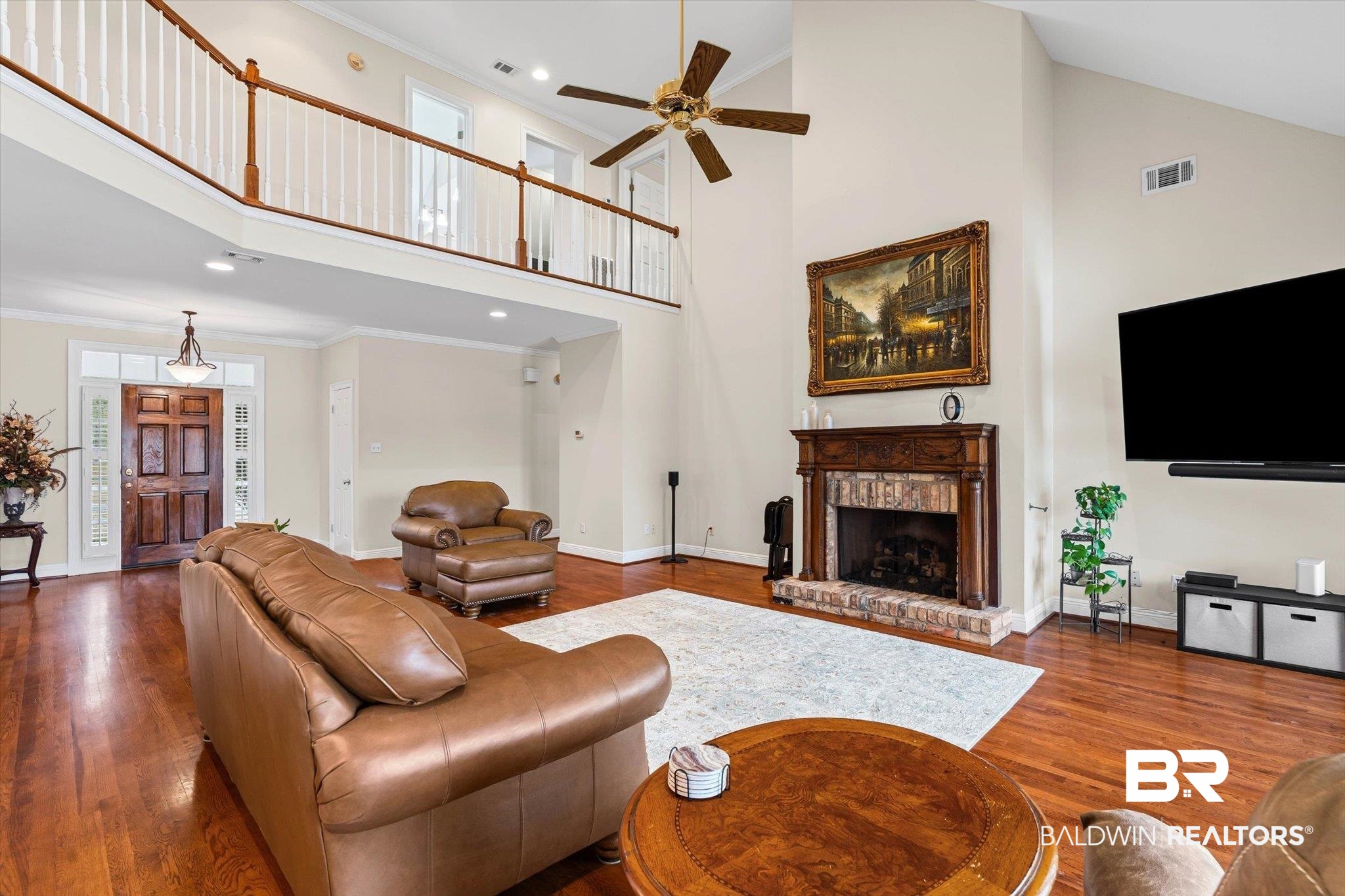 4851 Audubon Drive Mobile, AL 36619 - Photo 4 of 46 Living room featuring ornamental molding, a towering ceiling, dark wood-type flooring, a brick fireplace, and recessed lighting