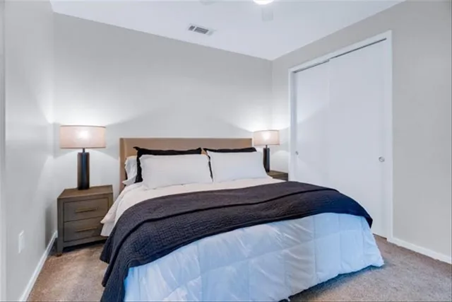 a bedroom with a bed and a lamp