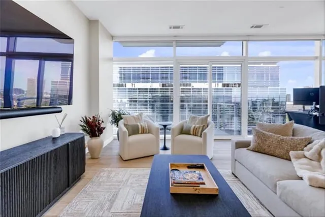 a living room with furniture and a floor to ceiling window