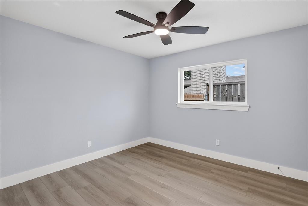 2005 Chestnut Road Carrollton, TX 75007 - Photo 21 of 35 an empty room with wooden floor and windows