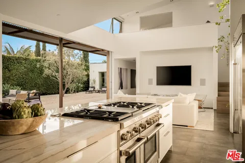 a bedroom with a bed and a view of living room
