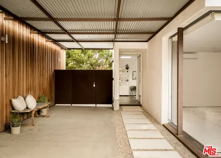 a view of a dinning table and chairs in patio of the house