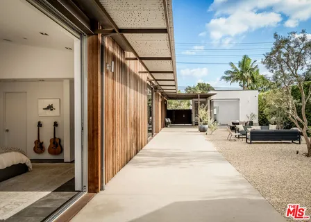 a view of a patio with table and chairs and potted plants