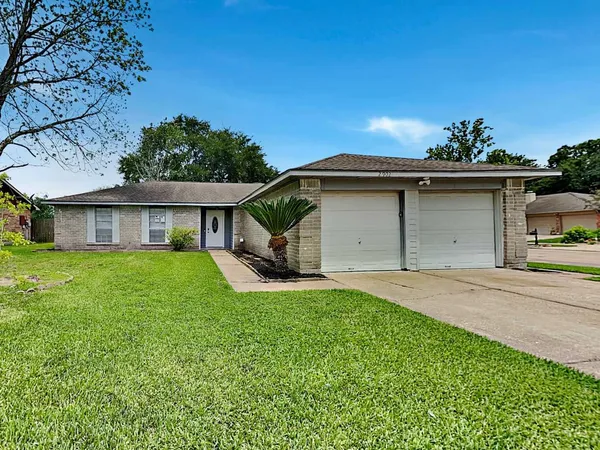 a front view of a house with a yard garage and outdoor seating