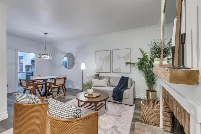 a living room with furniture a chandelier and a table
