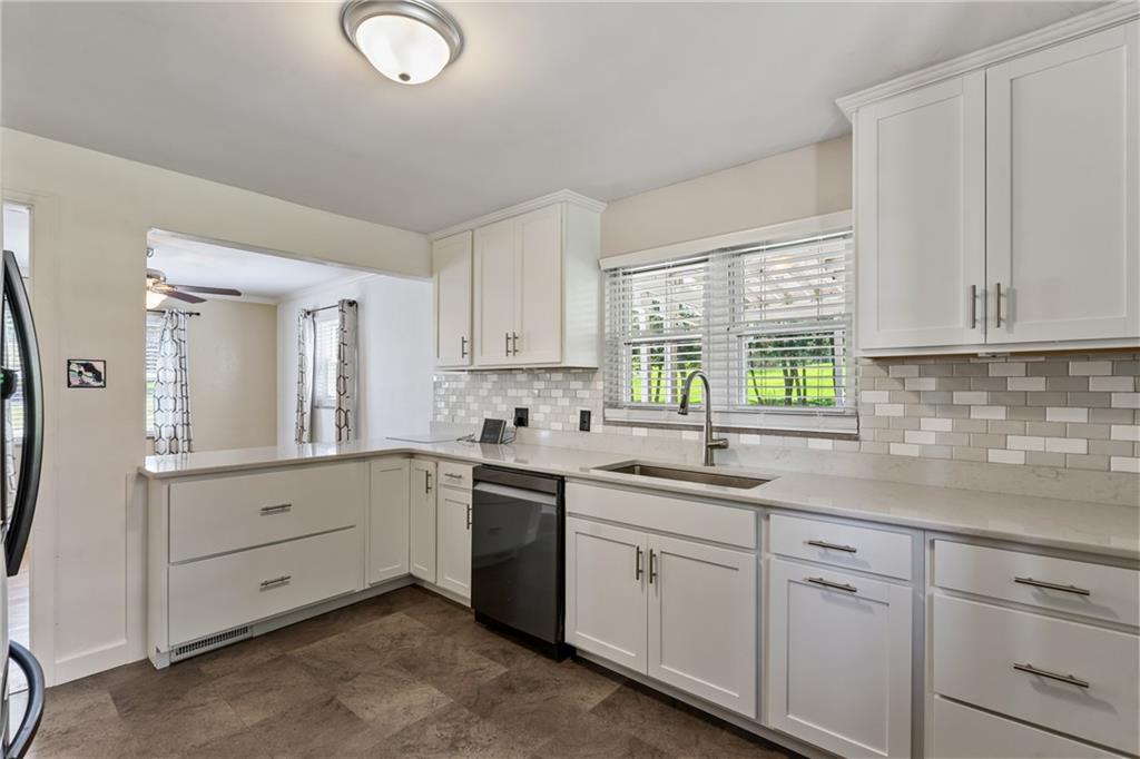 9515 Orchard Road Pittsburgh, PA 15237 - Photo 11 of 28 a kitchen with cabinets appliances a sink and a window