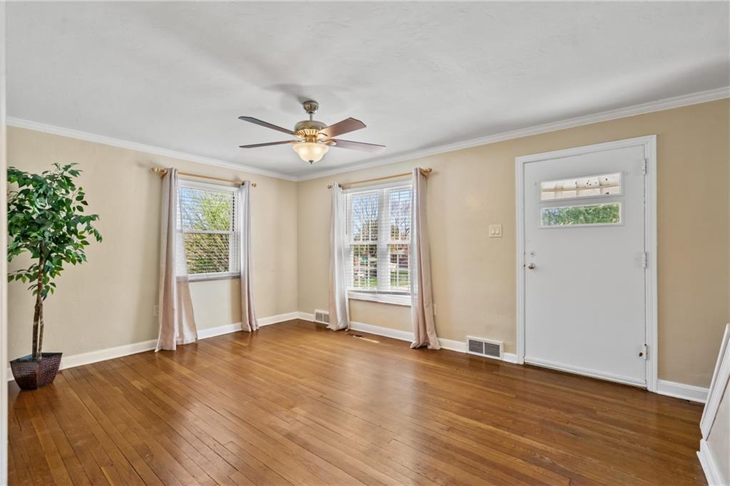 9515 Orchard Road Pittsburgh, PA 15237 - Photo 3 of 28 a view of an empty room with a window and wooden floor