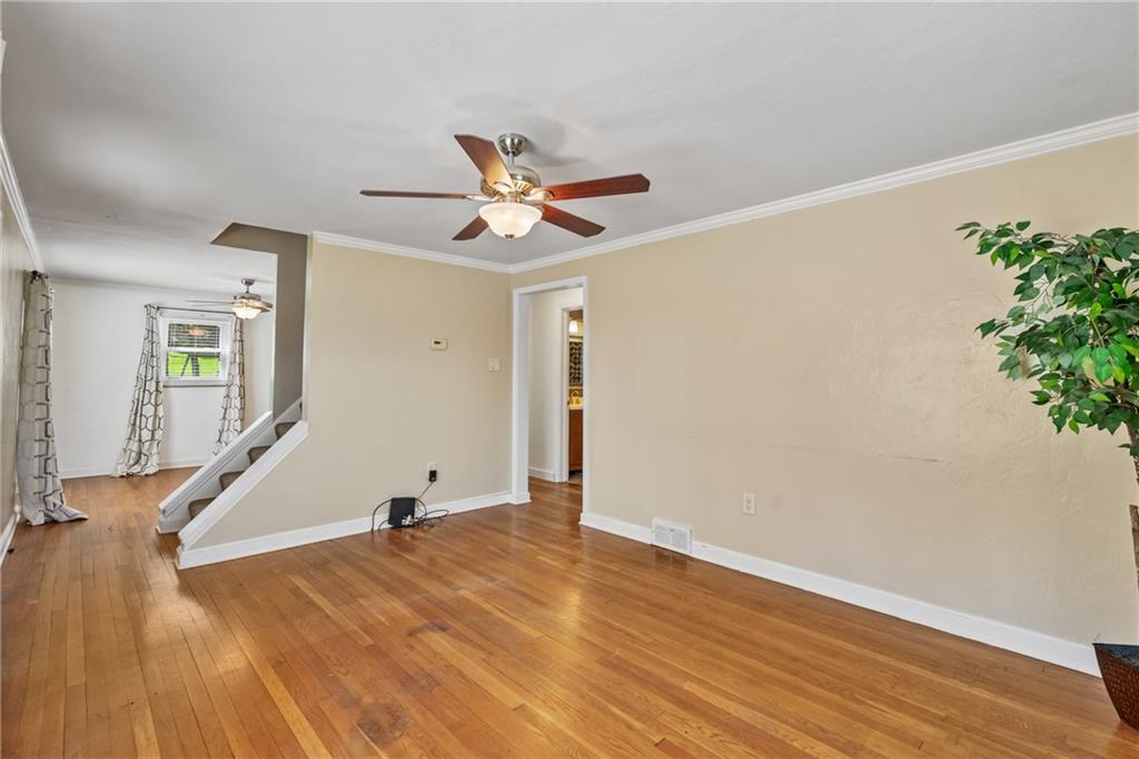9515 Orchard Road Pittsburgh, PA 15237 - Photo 5 of 28 a view of a room with wooden floor and a ceiling fan