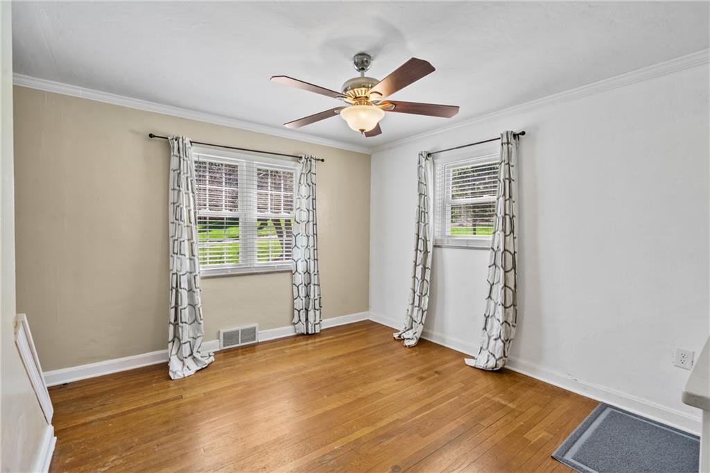 9515 Orchard Road Pittsburgh, PA 15237 - Photo 7 of 28 an empty room with wooden floor fan and windows
