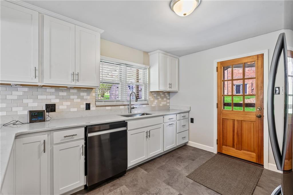 9515 Orchard Road Pittsburgh, PA 15237 - Photo 8 of 28 a kitchen with white cabinets and sink