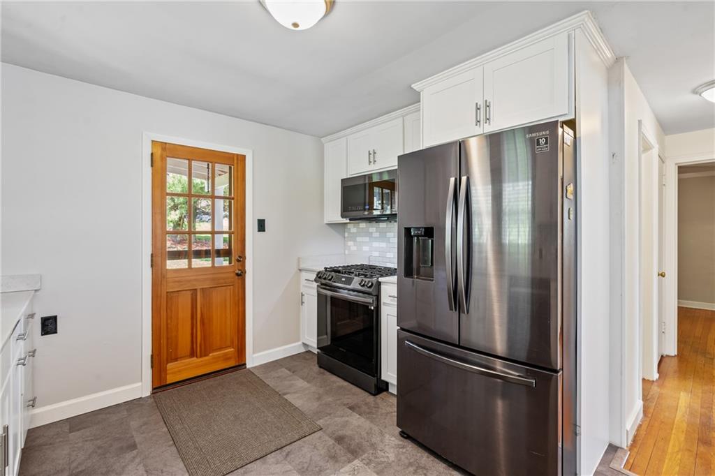 9515 Orchard Road Pittsburgh, PA 15237 - Photo 9 of 28 a kitchen with stainless steel appliances granite countertop a refrigerator and a stove