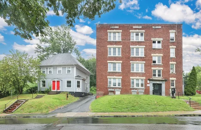 a view of a brick building next to a yard