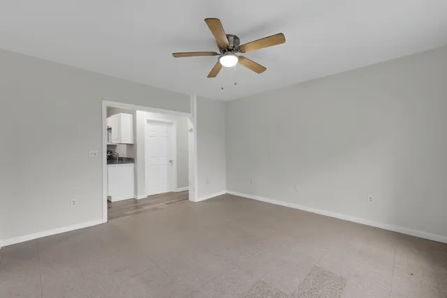 an empty room with closet and windows