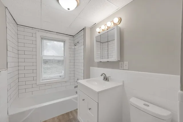 a bathroom with a sink a toilet and bathtub