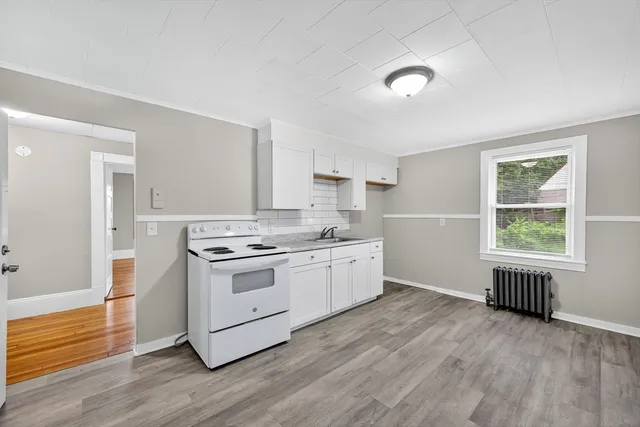 a kitchen with a stove a sink and a refrigerator
