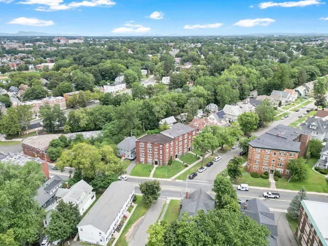 an aerial view of residential houses with outdoor space and street view