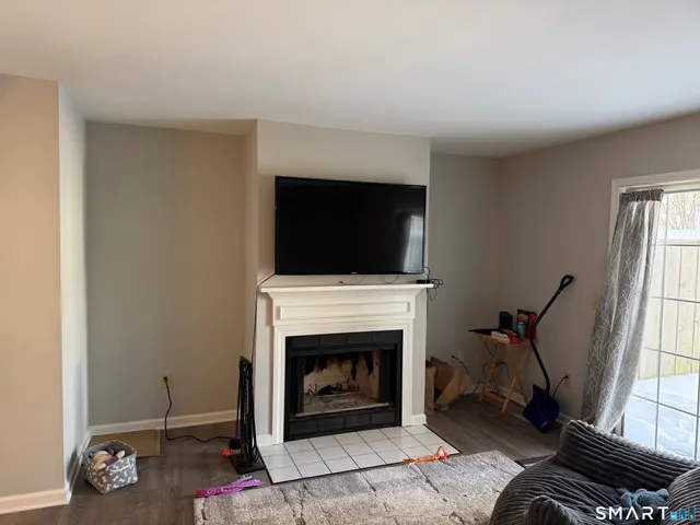 a living room with furniture a fireplace and a flat screen tv