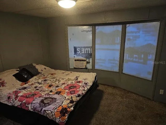 a bedroom with a bed and window