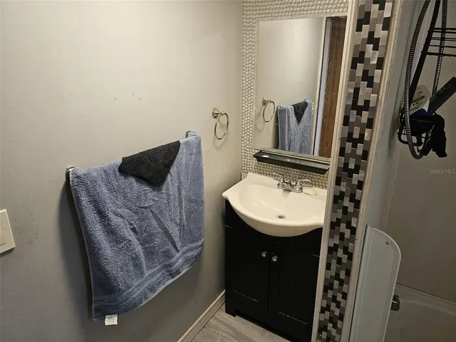 a bathroom with a sink and mirror