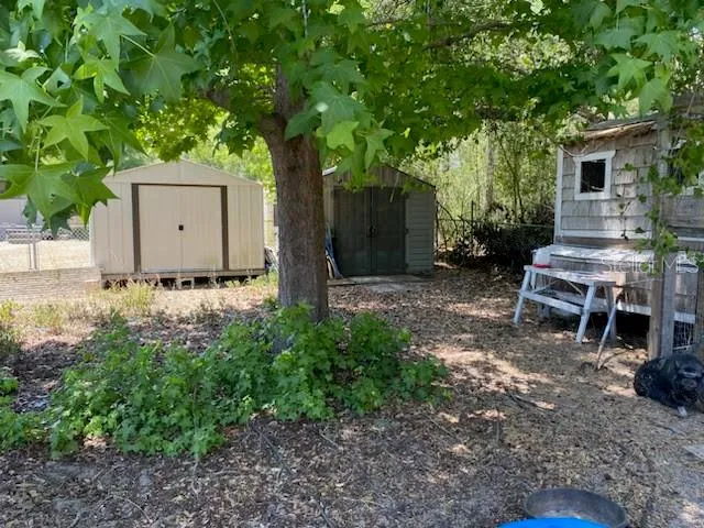 a view of a wooden house with a yard