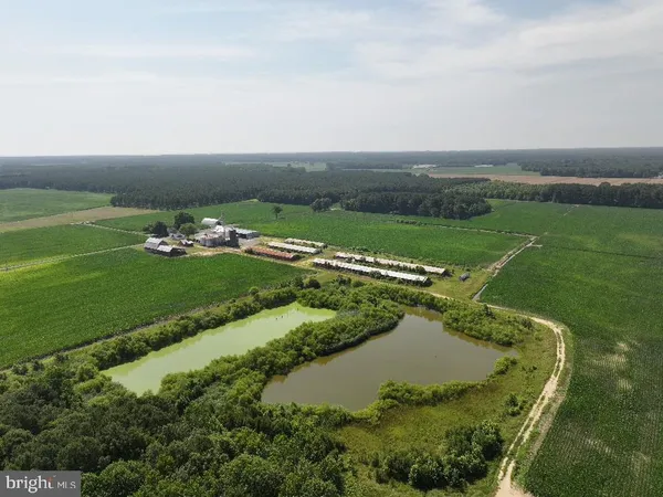 an aerial view of a golf course with a lake view