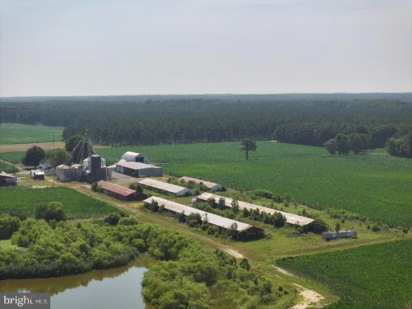 an aerial view of a house with a yard and lake view