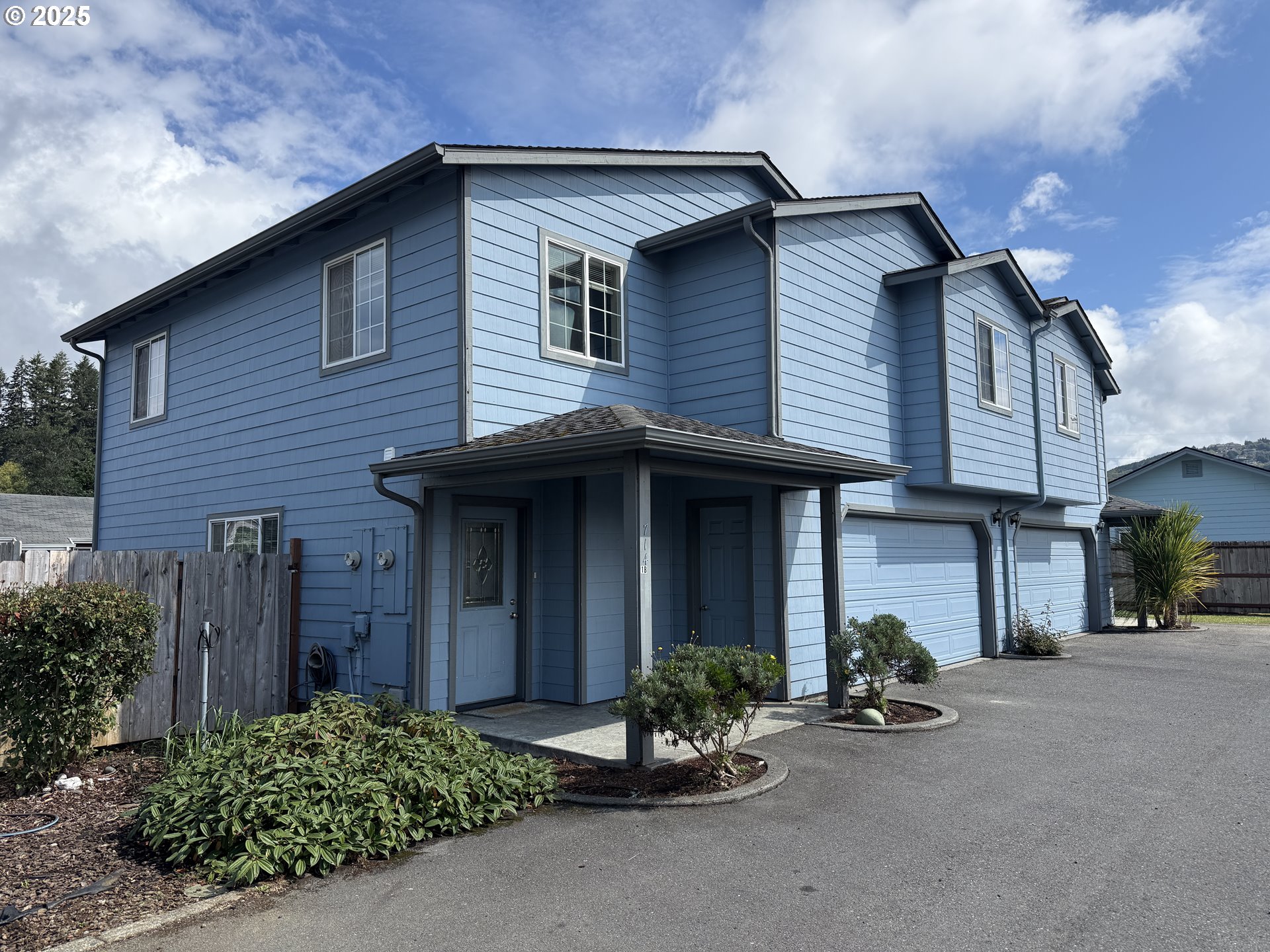 714 Pioneer Road, Unit 1B Brookings, OR 97415 - Photo 1 of 42 a front view of a house with yard and potted plants