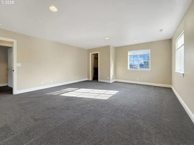 an empty room with a empty space and windows