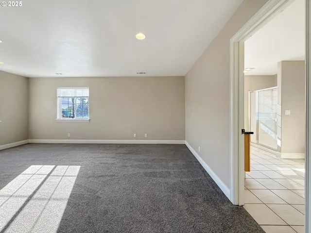 an empty room with windows and entrance