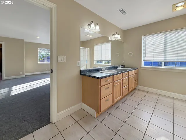 a kitchen with stainless steel appliances granite countertop a sink and a stove