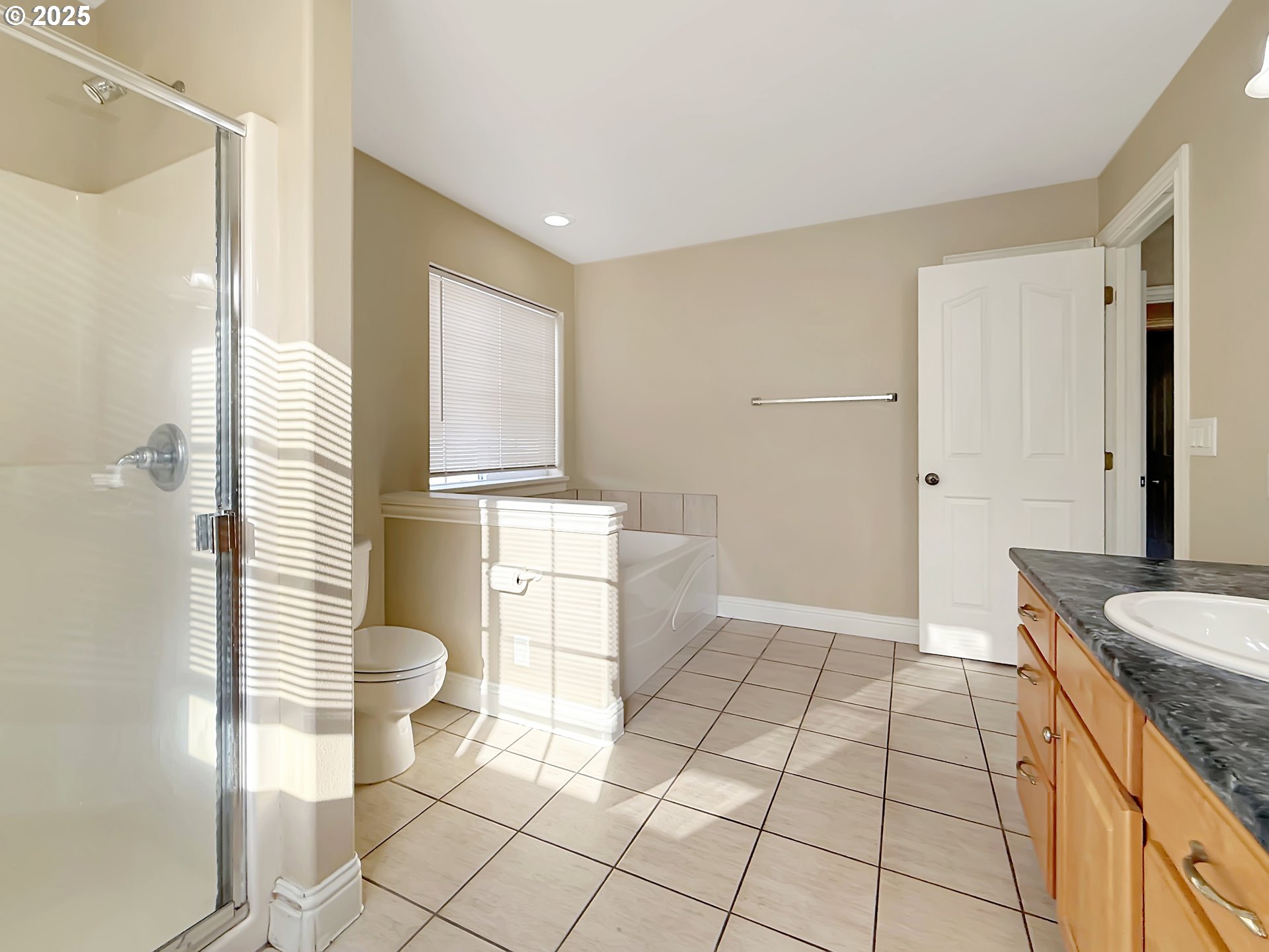 714 Pioneer Road, Unit 1B Brookings, OR 97415 - Photo 24 of 42 a bathroom with a granite countertop sink a toilet a mirror and shower