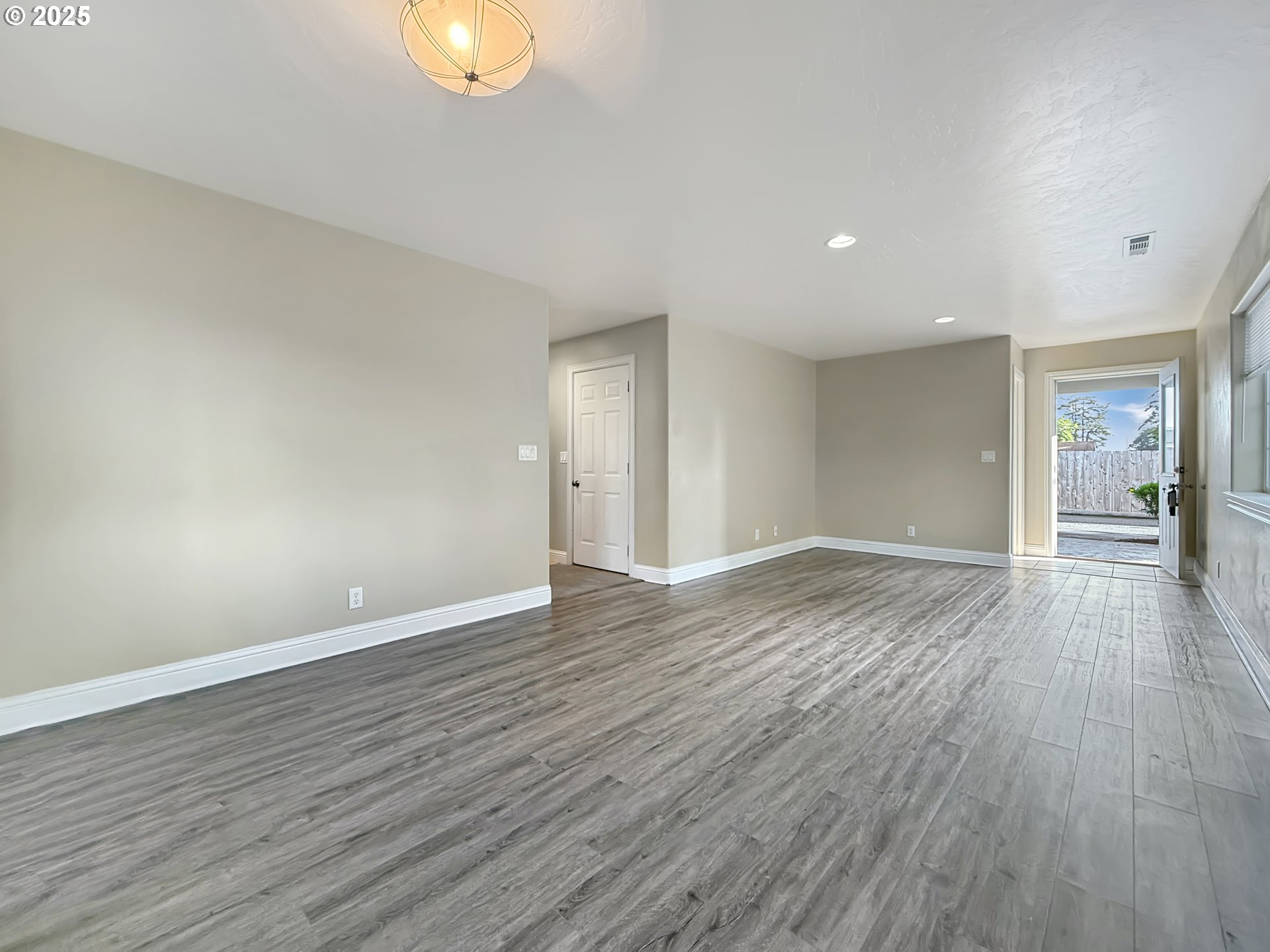 714 Pioneer Road, Unit 1B Brookings, OR 97415 - Photo 4 of 42 a view of an empty room with wooden floor