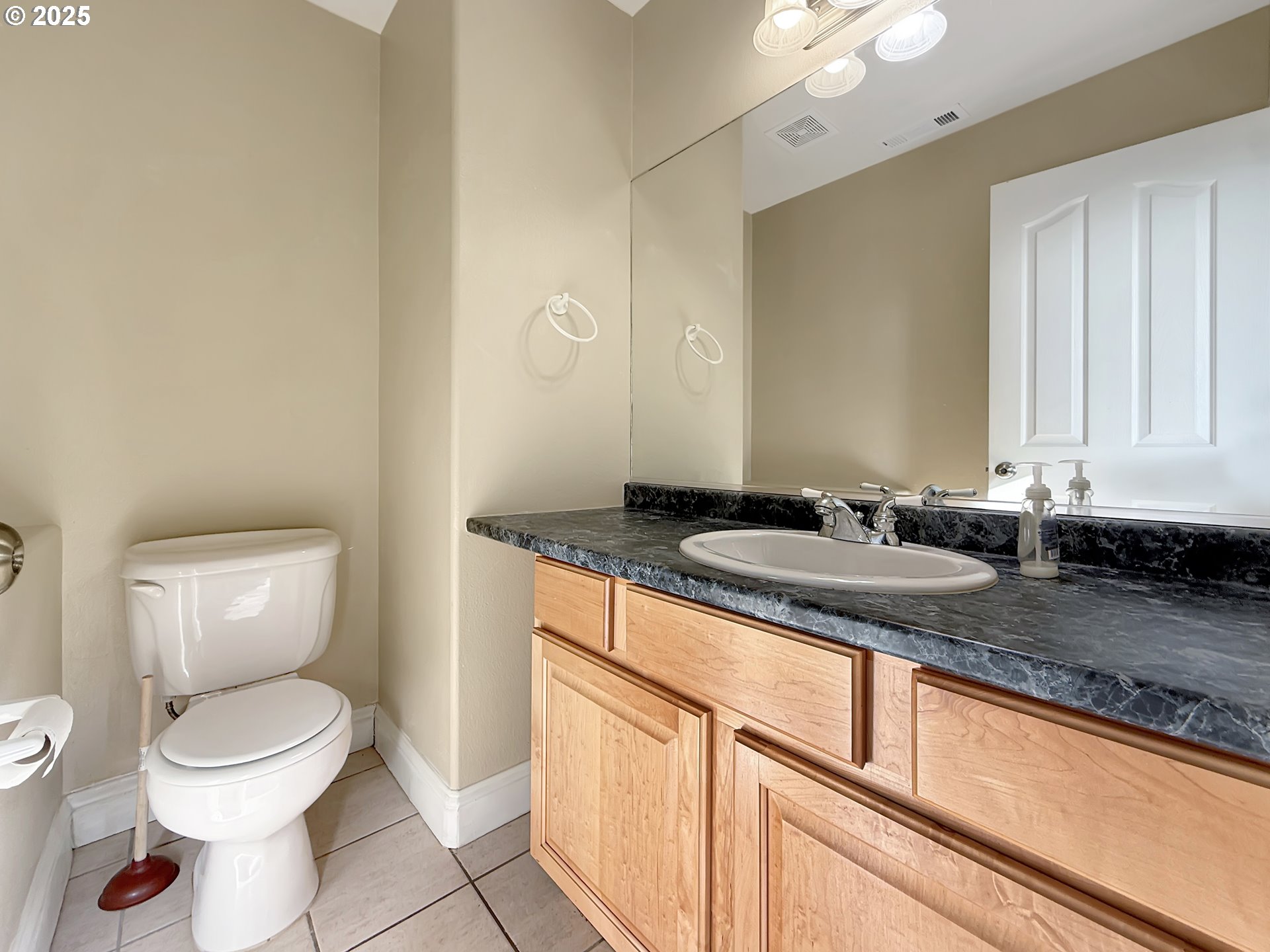 714 Pioneer Road, Unit 1B Brookings, OR 97415 - Photo 6 of 42 a bathroom with a granite countertop sink a toilet and a mirror