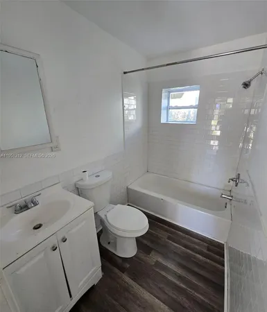 a bathroom with a sink a toilet and bathtub