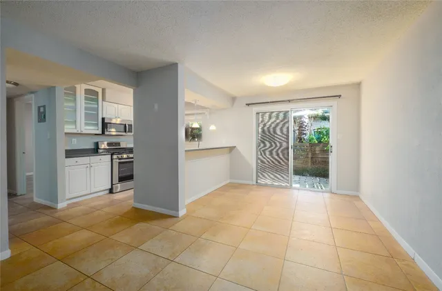 a view of kitchen with granite countertop cabinets and outdoor space