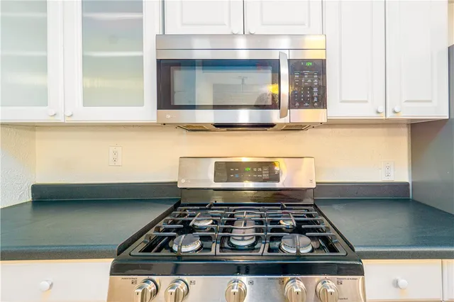 a stove top oven sitting inside of a kitchen