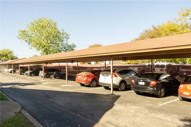 a view of a parking space with cars