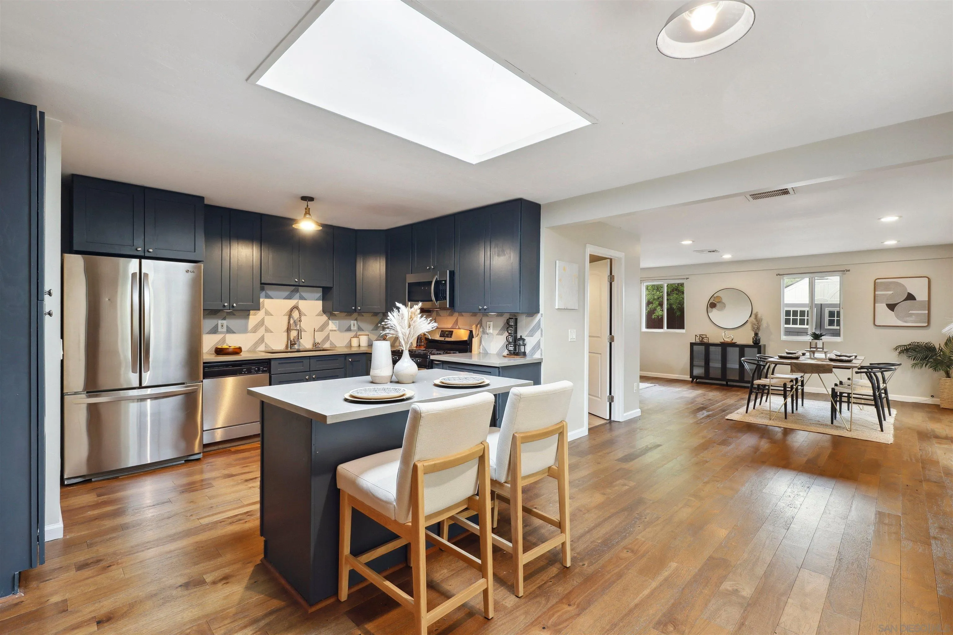 1390 Orpheus Avenue Encinitas, CA 92024 - Photo 1 of 32 a view of a dining room with furniture wooden floor and a kitchen