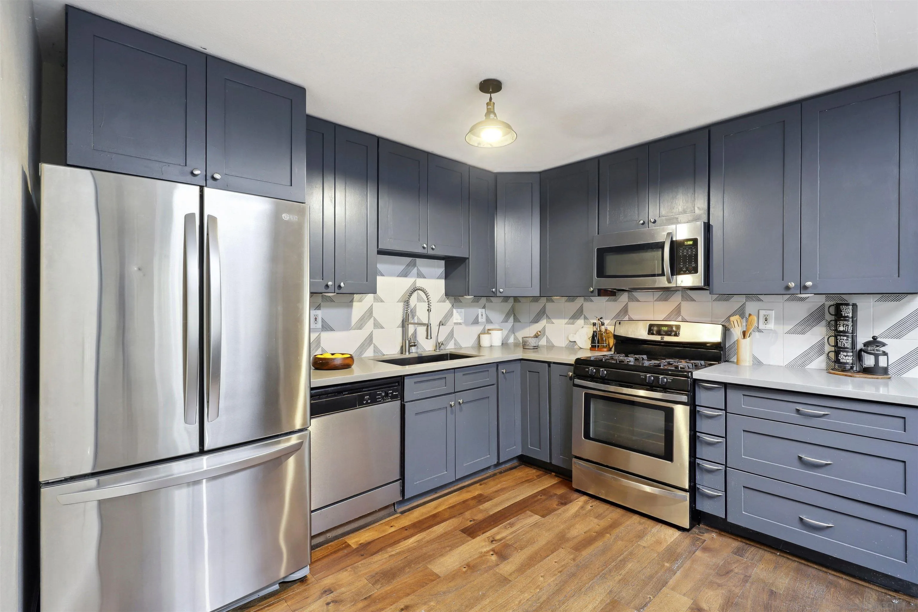 1390 Orpheus Avenue Encinitas, CA 92024 - Photo 12 of 32 a kitchen with granite countertop stainless steel appliances and wooden cabinets