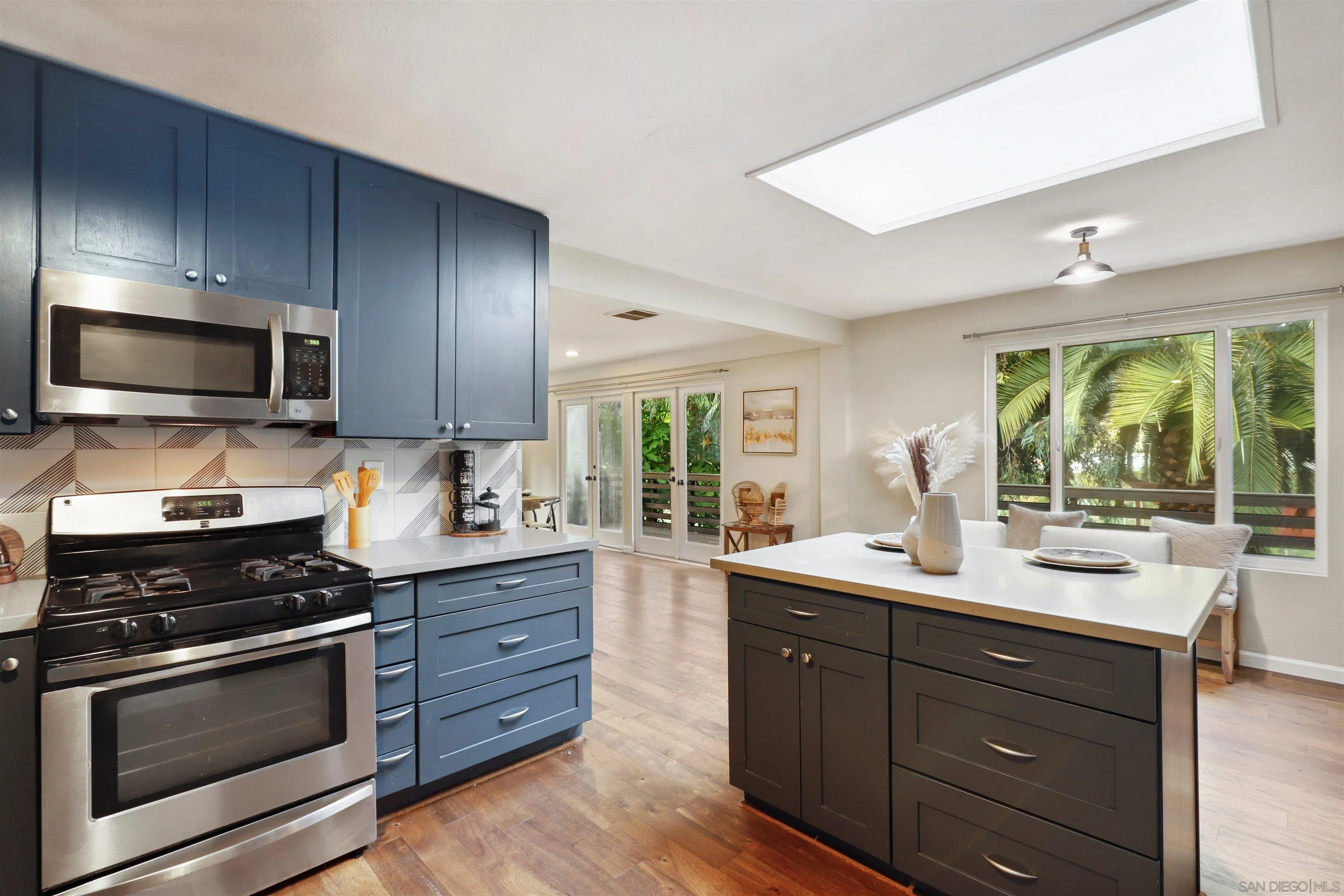 1390 Orpheus Avenue Encinitas, CA 92024 - Photo 14 of 32 a kitchen with a sink stove and microwave