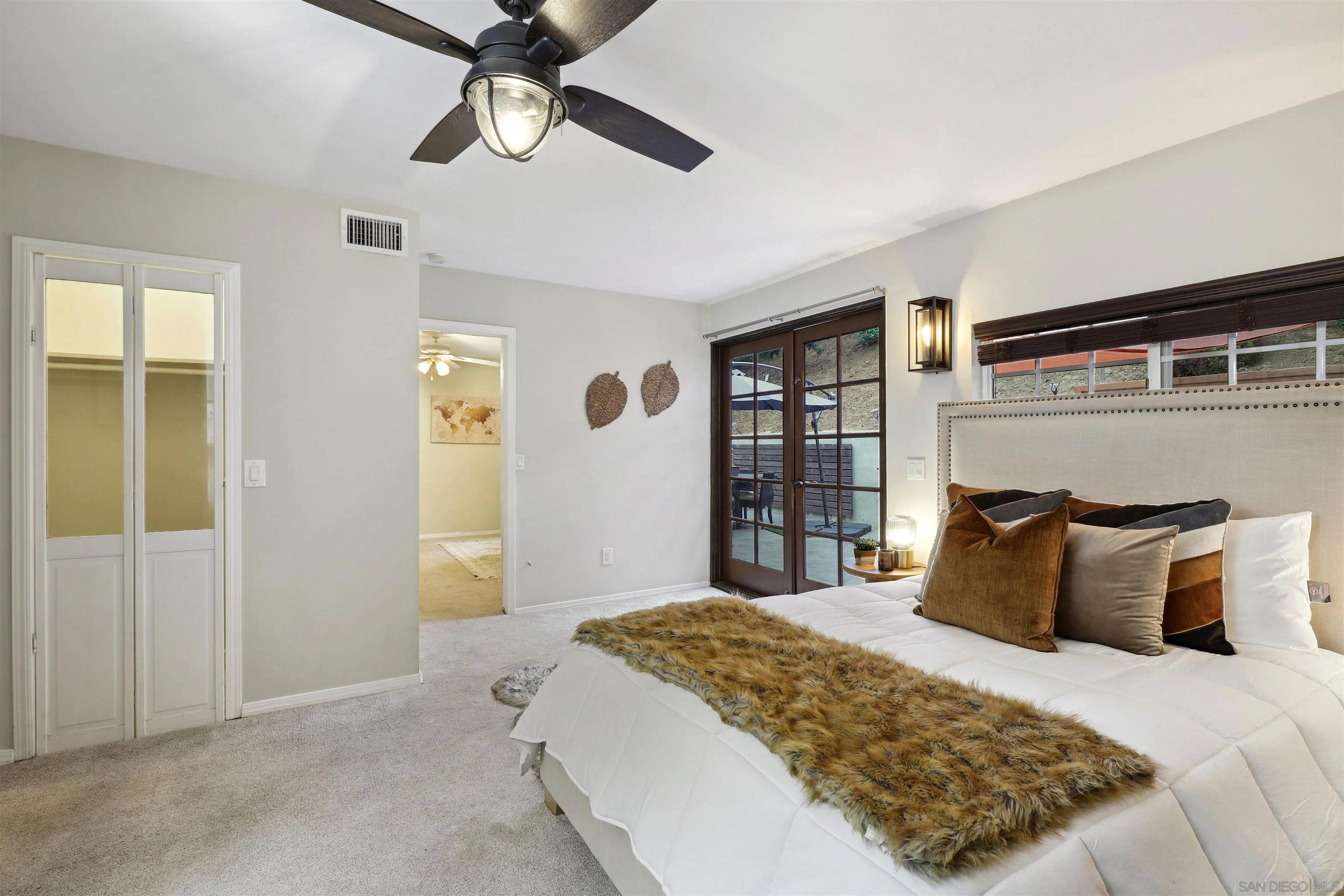 1390 Orpheus Avenue Encinitas, CA 92024 - Photo 16 of 32 a bedroom with a large bed and a window