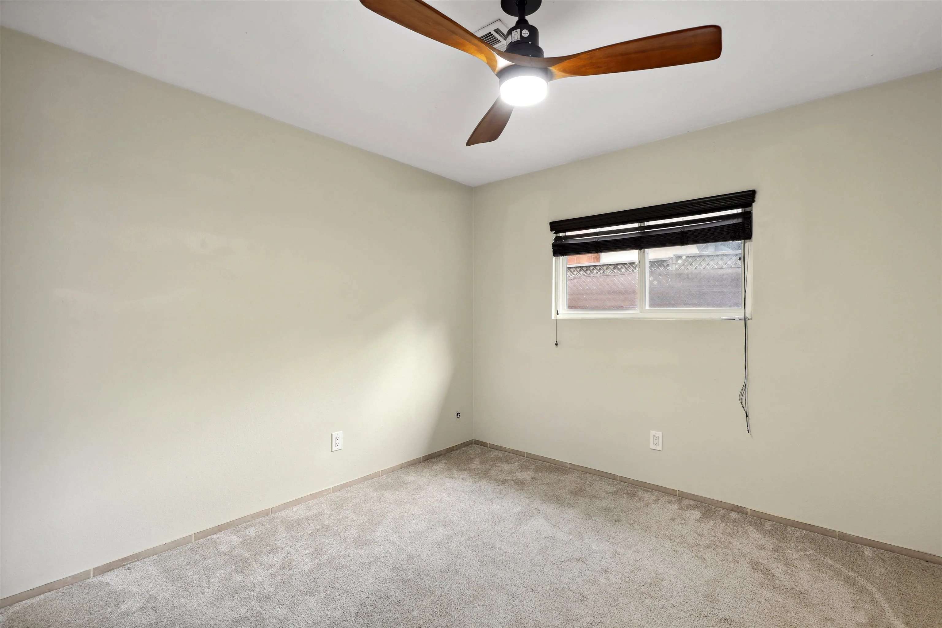 1390 Orpheus Avenue Encinitas, CA 92024 - Photo 19 of 32 an empty room with a chandelier fan and windows