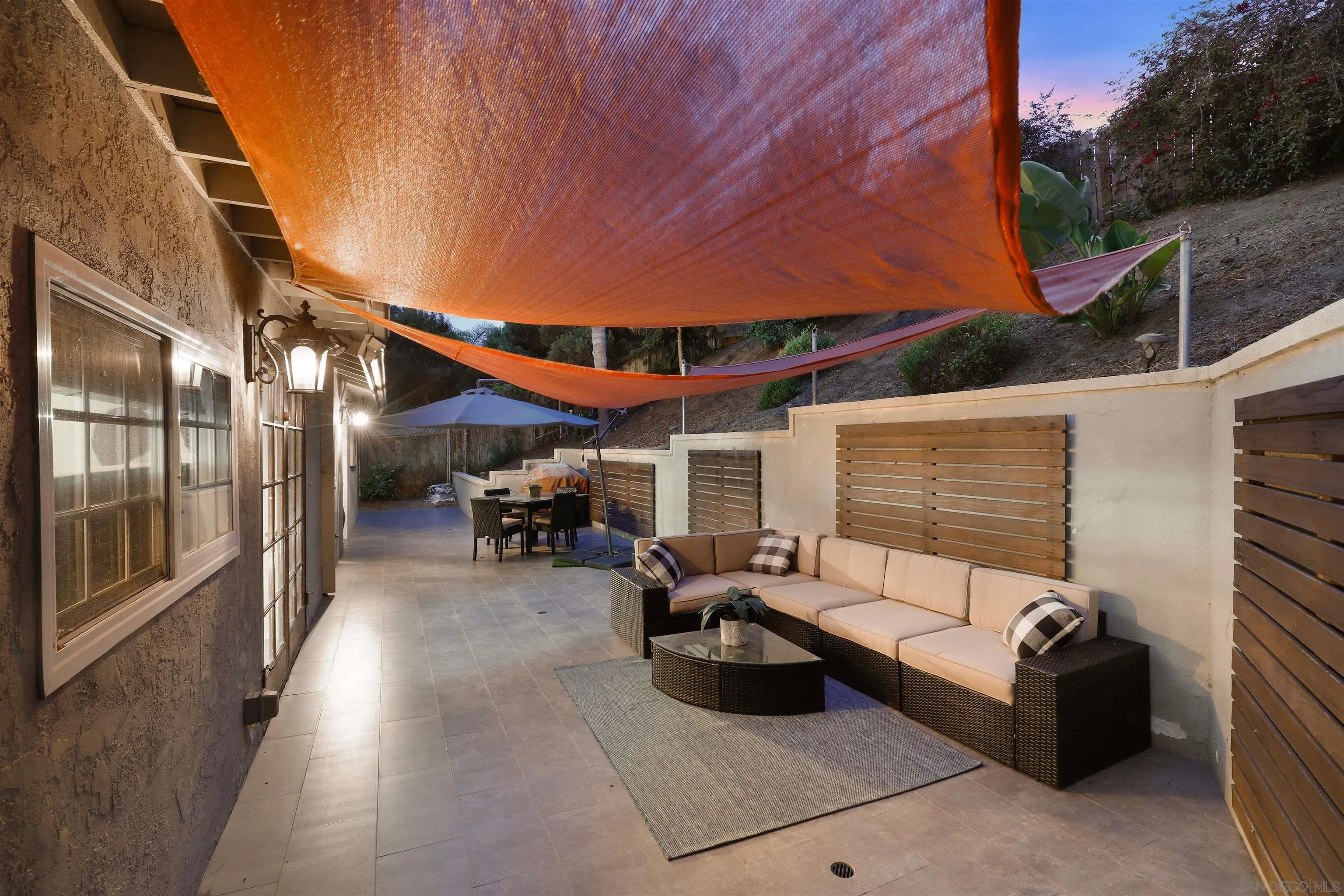 1390 Orpheus Avenue Encinitas, CA 92024 - Photo 29 of 32 a view of a patio with table and chairs under an umbrella with a barbeque