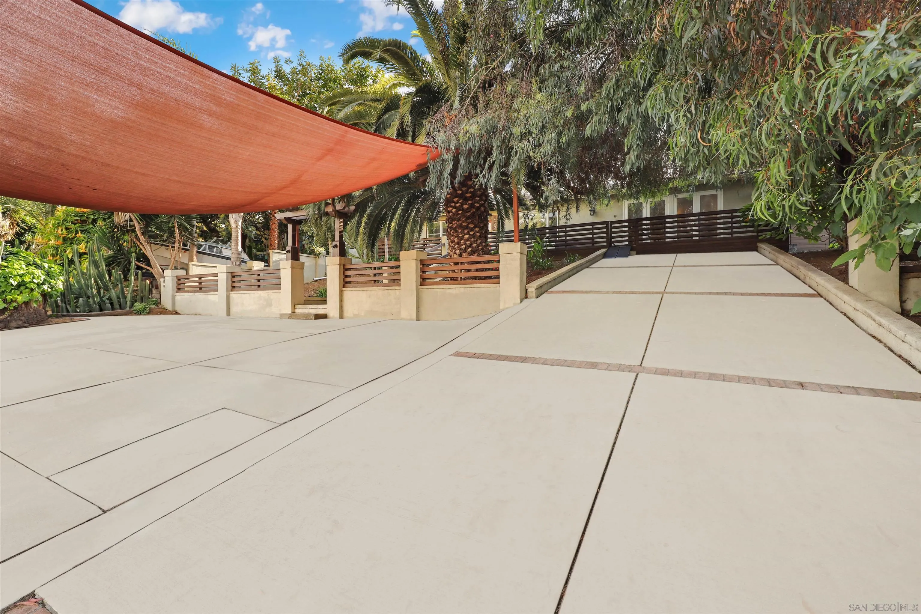 1390 Orpheus Avenue Encinitas, CA 92024 - Photo 32 of 32 a patio with table and chairs under an umbrella