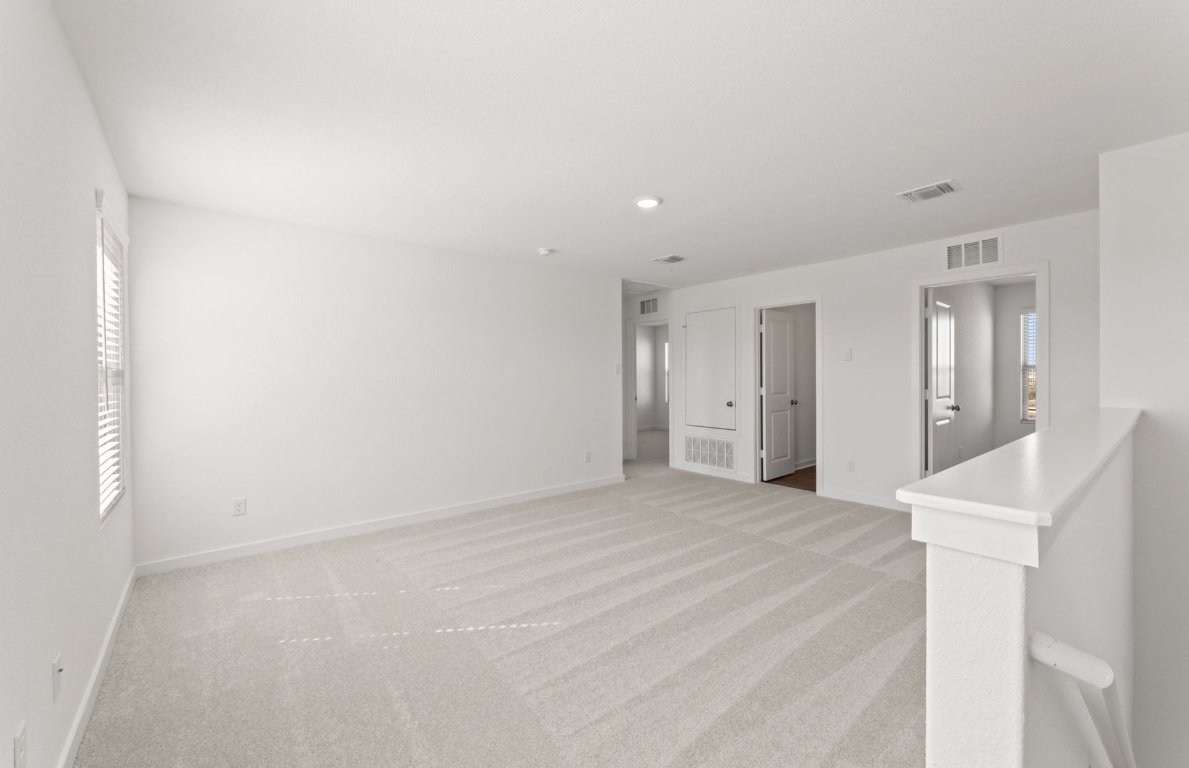 401 The Duke Drive Jarrell, TX 76537 - Photo 14 of 25 a view of an empty room with wooden floor