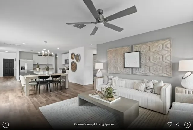 a living room with furniture kitchen view and a table